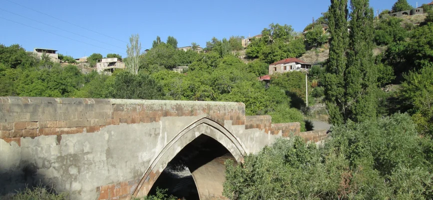 Pointed stone arch of Ashtarak Old Bridge and vegetation in Kasagh Gorge