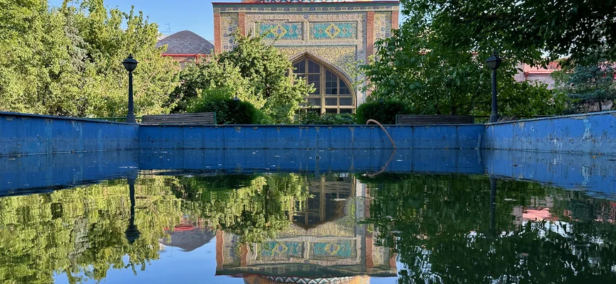Blue dome of Yerevan Blue Mosque reflected in the courtyard pool