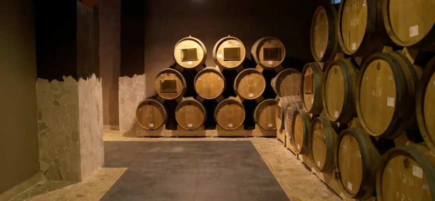 Rows of aging barrels in a Yerevan Brandy Company cellar